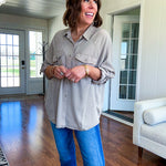 Lightweight Tencel button down top in taupe with adjustable sleeves and front pockets.