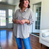 Lightweight Tencel button down top in taupe with adjustable sleeves and front pockets.