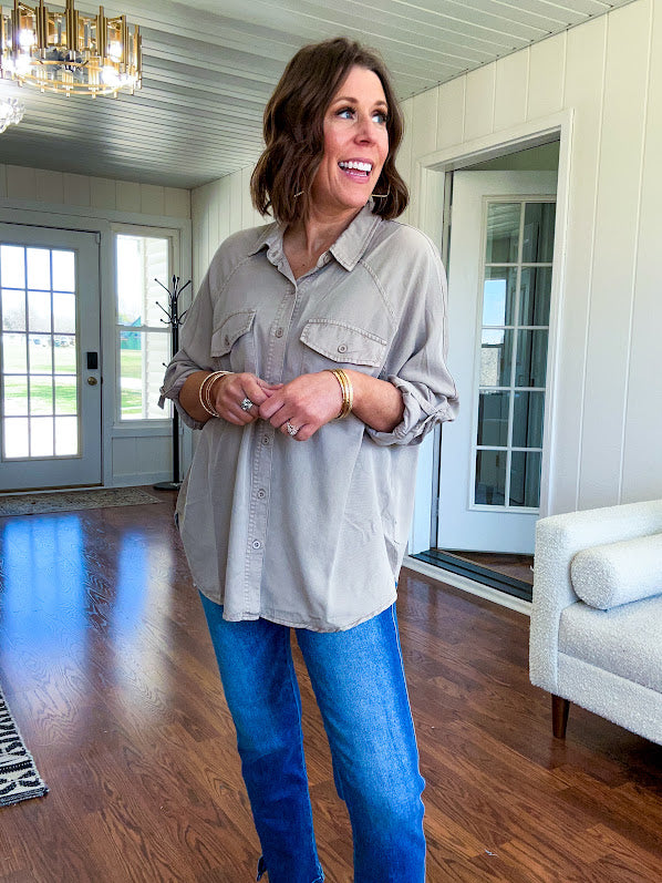 Lightweight Tencel button down top in taupe with adjustable sleeves and front pockets.