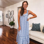 Dusty blue midi dress with white eyelet and floral embroidery throughout, gathered bust, stretchy wide straps and pockets.