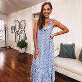 Dusty blue midi dress with white eyelet and floral embroidery throughout, gathered bust, stretchy wide straps and pockets.