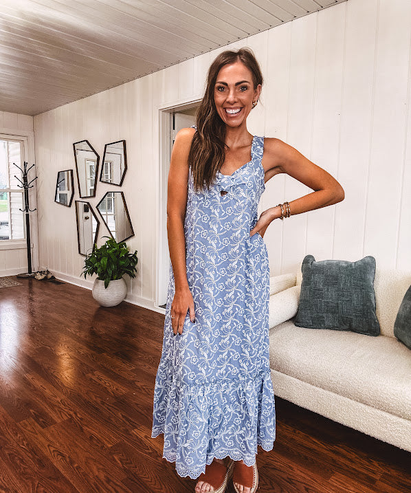 Dusty blue midi dress with white eyelet and floral embroidery throughout, gathered bust, stretchy wide straps and pockets.