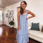Dusty blue midi dress with white eyelet and floral embroidery throughout, gathered bust, stretchy wide straps and pockets.