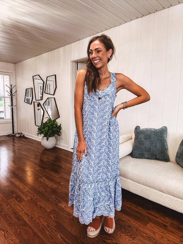 Dusty blue midi dress with white eyelet and floral embroidery throughout, gathered bust, stretchy wide straps and pockets.