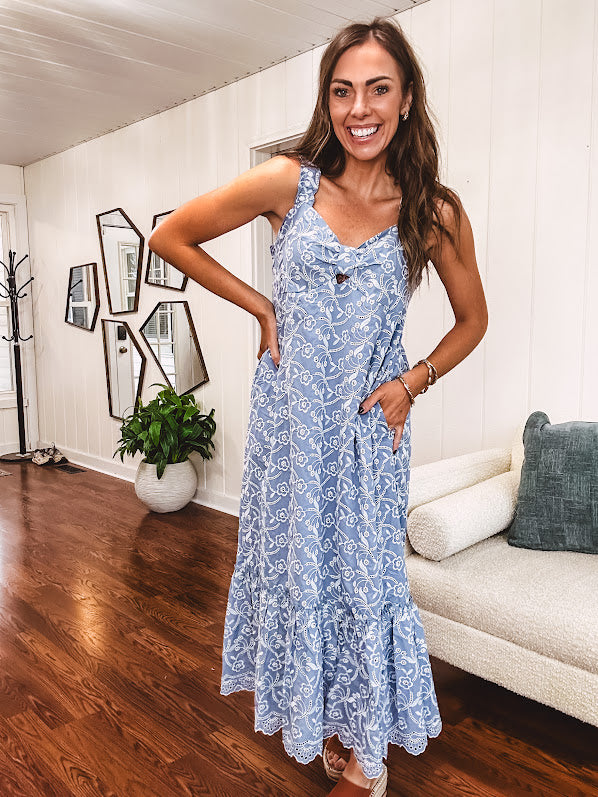 Dusty blue midi dress with white eyelet and floral embroidery throughout, gathered bust, stretchy wide straps and pockets.