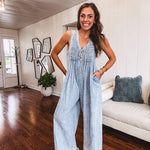 Light wash, lightweight denim jumpsuit with pintuck detail at the top, tie V neck, wide leg design and pockets.