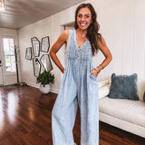 Light wash, lightweight denim jumpsuit with pintuck detail at the top, tie V neck, wide leg design and pockets.