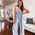 Light wash, lightweight denim jumpsuit with pintuck detail at the top, tie V neck, wide leg design and pockets.