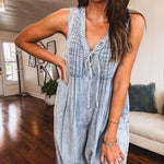 Light wash, lightweight denim jumpsuit with pintuck detail at the top, tie V neck, wide leg design and pockets.
