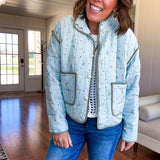 Mint green light weight quilted jacket with olive and white mini florals throughout and olive trim with snap button front and pockets.