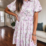 Fully lined , short lavender multi floral shirt dress with elastic waist, matching fabric belt, puff sleeves and tiered skirt.