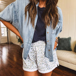 3/4 sleeve light wash chambray button down shirt with front pocket.
