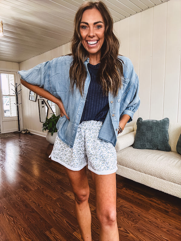 3/4 sleeve light wash chambray button down shirt with front pocket.
