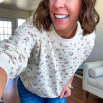 Soft, lightweight long sleeved crew in cream with dainty pink florals throughout.