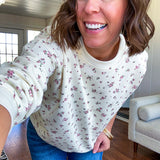 Soft, lightweight long sleeved crew in cream with dainty pink florals throughout.