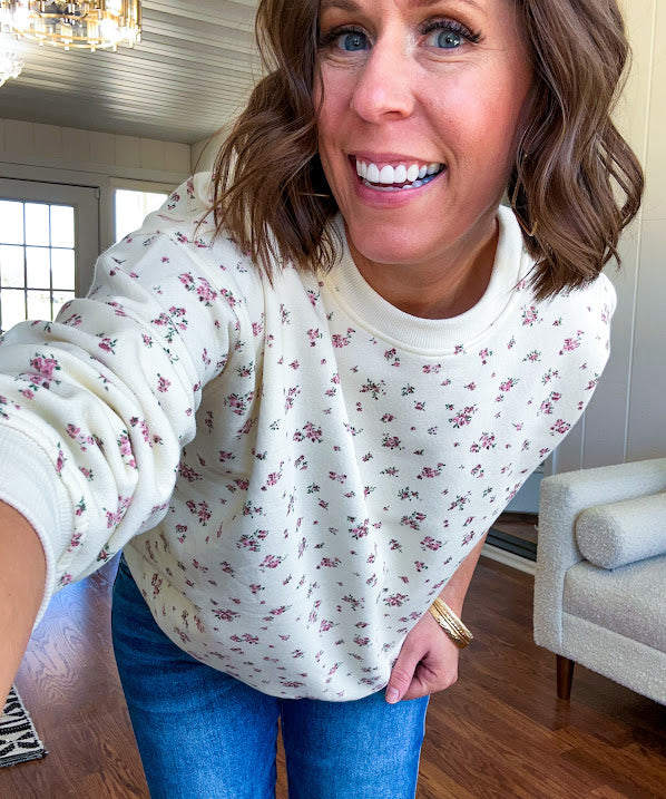 Soft, lightweight long sleeved crew in cream with dainty pink florals throughout.