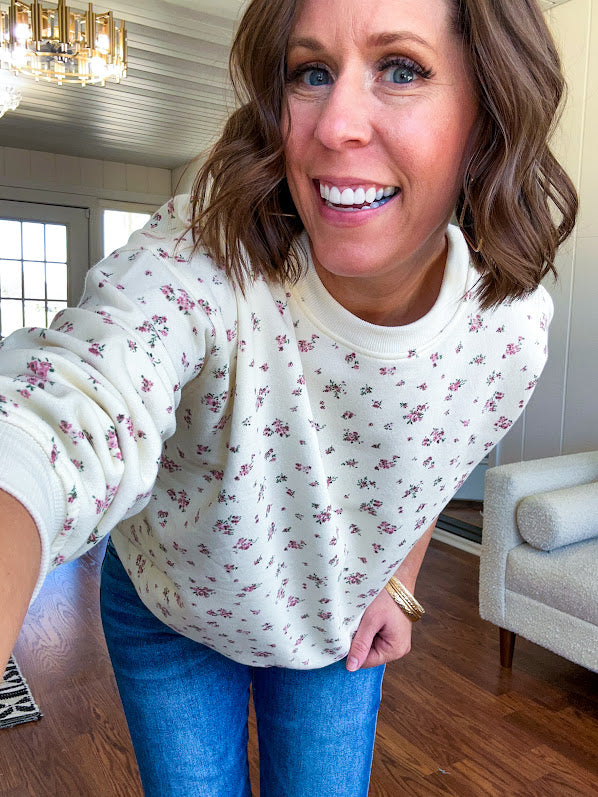 Soft, lightweight long sleeved crew in cream with dainty pink florals throughout.