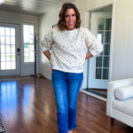 Soft, lightweight long sleeved crew in cream with dainty pink florals throughout.