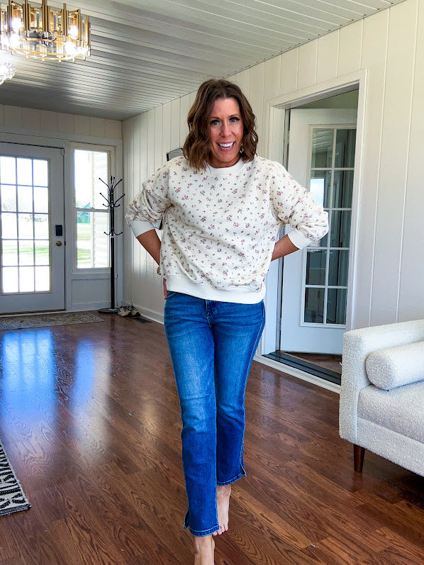 Soft, lightweight long sleeved crew in cream with dainty pink florals throughout.