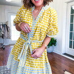 Fully lined short sleeved short dress with mustard polka dots trimmed in dusty blue, mustard and cream stripes at the mock neck and placket, ruffled cuffs, belt and hem.