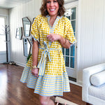 Fully lined short sleeved short dress with mustard polka dots trimmed in dusty blue, mustard and cream stripes at the mock neck and placket, ruffled cuffs, belt and hem.