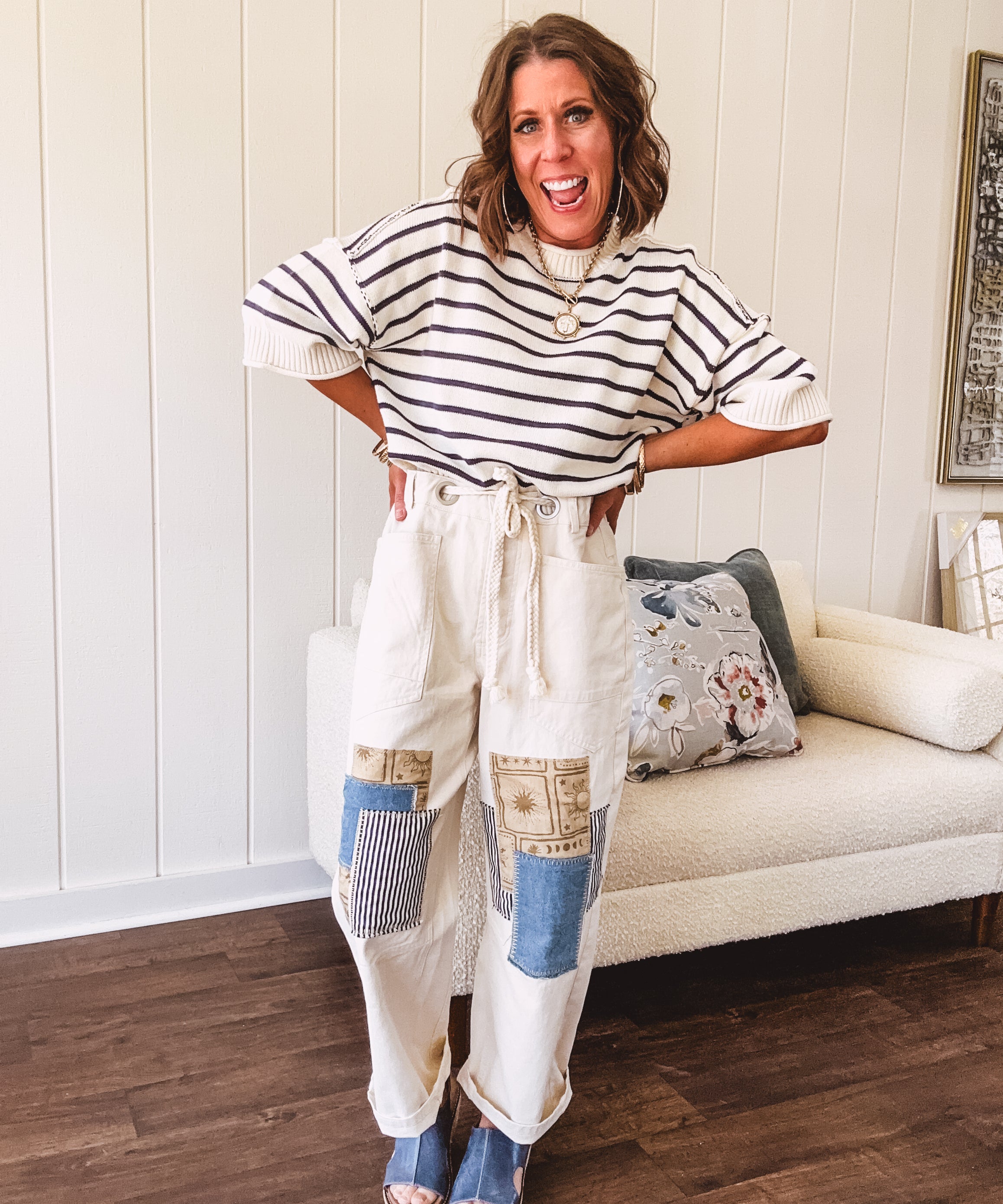 Creamy wide-leg pants, denim-like cotton material with silver grommet belt loops and a coordinating rope belt, button fly and oversized pockets, and striped patchwork in sand, denim, navy, and white creates visual interest down the legs.
