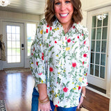 Cream 3/4 sleeve button down top with collar and pleating at the yoke with red, yellow and green florals throughout.