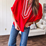 Cool red dolman style top with white and red gingham trim at the mock neck and yoke.