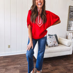 Cool red dolman style top with white and red gingham trim at the mock neck and yoke.