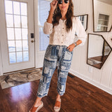 Short sheer beige button down long sleeved top with whimsical embroidery throughout and elastic cuffs.