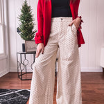 Wide leg button and zipper pants in ivory with black polka dots.