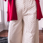 Wide leg button and zipper pants in ivory with black polka dots.