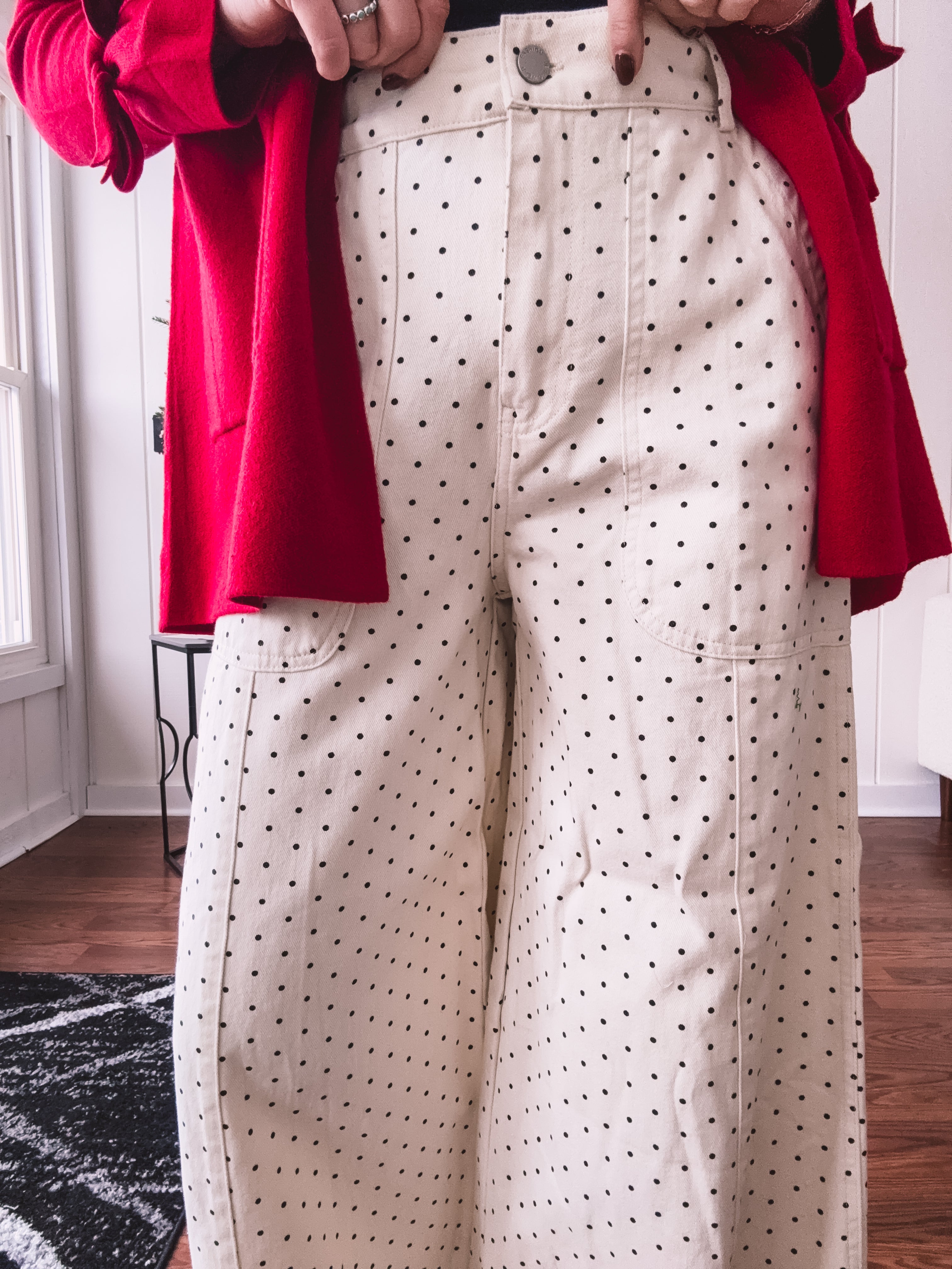 Wide leg button and zipper pants in ivory with black polka dots.