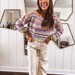 Lightweight cropped crochet long sleeved round neck pullover in pink, white, sage, orange and purple wave design.