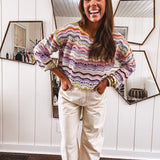 Lightweight cropped crochet long sleeved round neck pullover in pink, white, sage, orange and purple wave design.