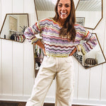 Lightweight cropped crochet long sleeved round neck pullover in pink, white, sage, orange and purple wave design.