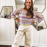 Lightweight cropped crochet long sleeved round neck pullover in pink, white, sage, orange and purple wave design.