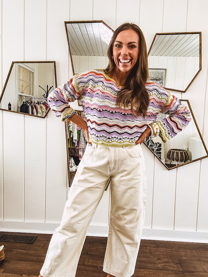 Lightweight cropped crochet long sleeved round neck pullover in pink, white, sage, orange and purple wave design.