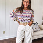 Lightweight cropped crochet long sleeved round neck pullover in pink, white, sage, orange and purple wave design.