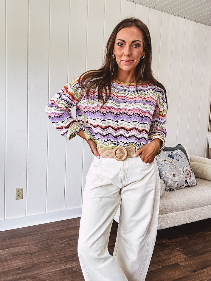 Lightweight cropped crochet long sleeved round neck pullover in pink, white, sage, orange and purple wave design.