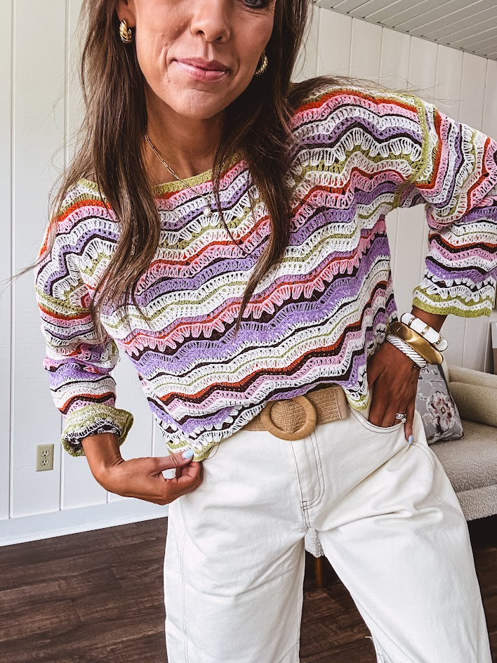 Lightweight cropped crochet long sleeved round neck pullover in pink, white, sage, orange and purple wave design.