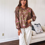 Thin chestnut brown boatneck crew with vintage inspired pink and green floral print and split front hem with exposed seams.