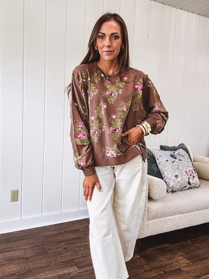 Thin chestnut brown boatneck crew with vintage inspired pink and green floral print and split front hem with exposed seams.