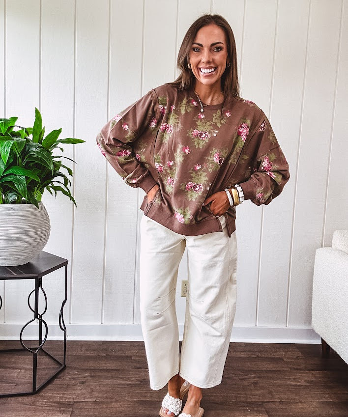 Thin chestnut brown boatneck crew with vintage inspired pink and green floral print and split front hem with exposed seams.