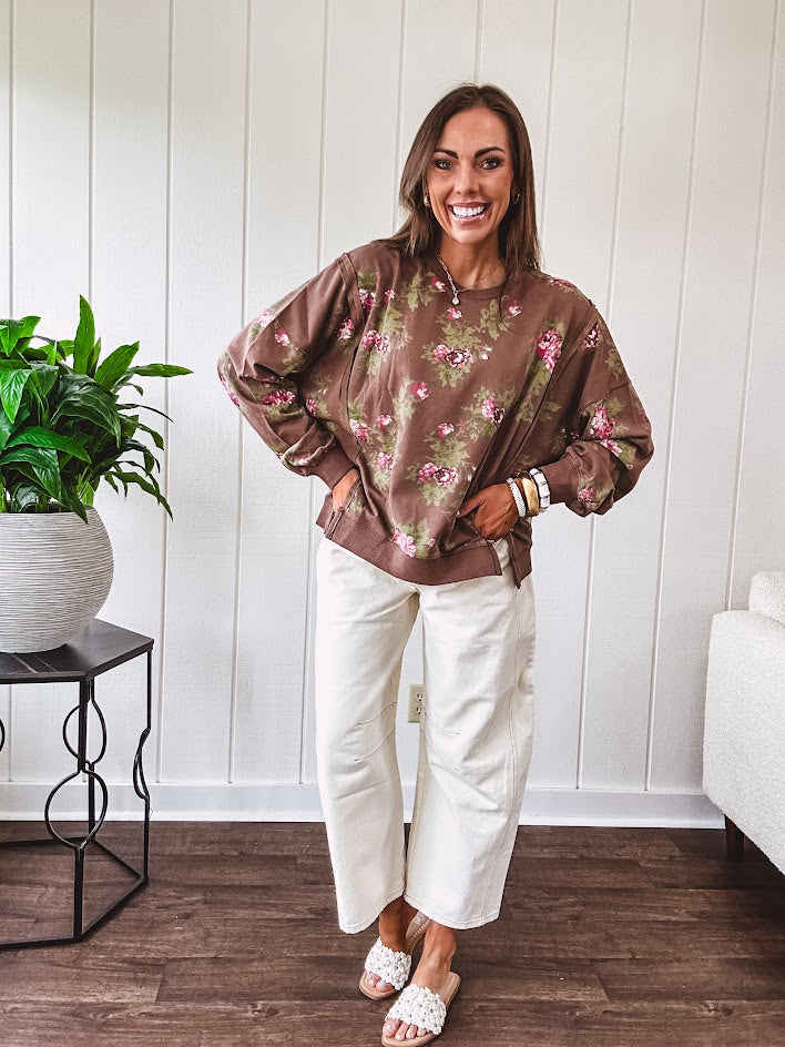 Thin chestnut brown boatneck crew with vintage inspired pink and green floral print and split front hem with exposed seams.