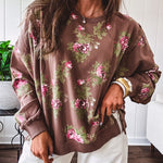 Thin chestnut brown boatneck crew with vintage inspired pink and green floral print and split front hem with exposed seams.