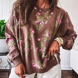Thin chestnut brown boatneck crew with vintage inspired pink and green floral print and split front hem with exposed seams.