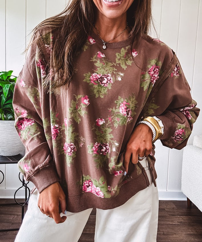Thin chestnut brown boatneck crew with vintage inspired pink and green floral print and split front hem with exposed seams.