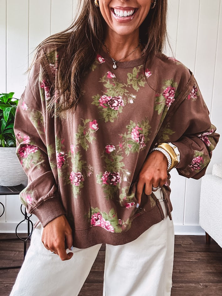 Thin chestnut brown boatneck crew with vintage inspired pink and green floral print and split front hem with exposed seams.