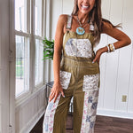 Light olive green washed cotton overalls with pastel floral patchwork throughout including on the adjustable traps with metal clasps and zippered sides.